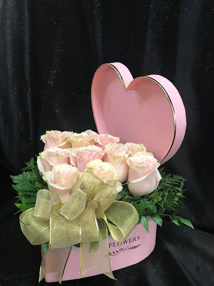 9 white roses in a pink, heart-shaped box from Flowers by Maria
