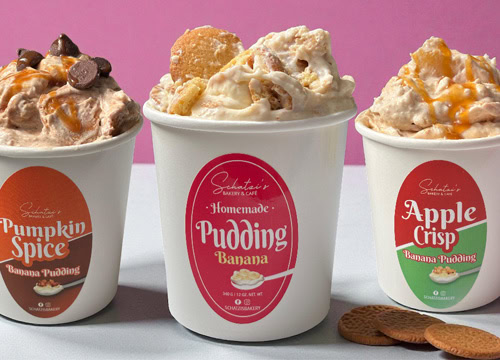 Three banana pudding cups with toppings, cookies, and colorful background.