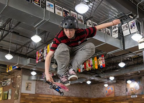 A skateboarder doing a trick in a skate park.
