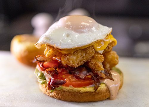 A sandwich with a fried egg on it.
