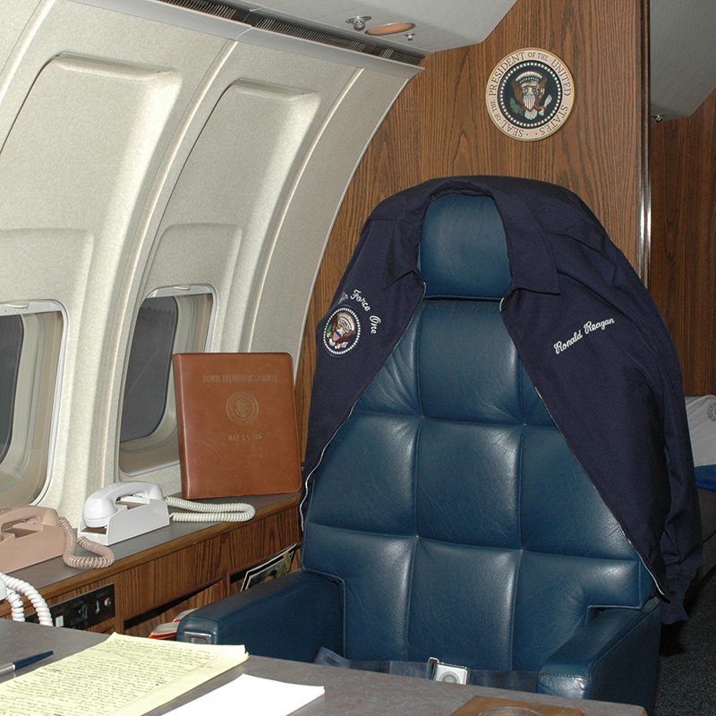 A blue leather chair in an airplane.