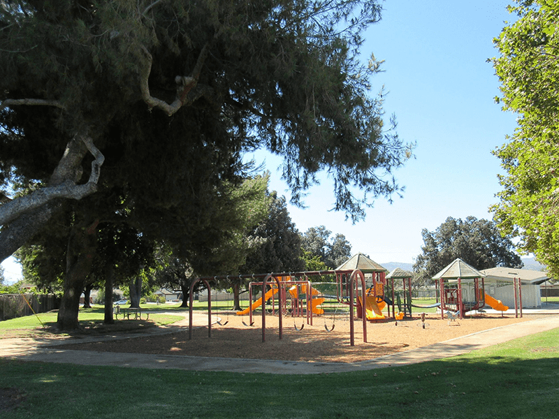 Arroyo Park playground with grass and trees surrounding