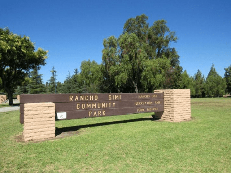 Rancho Simi Community Park sign with grass and trees