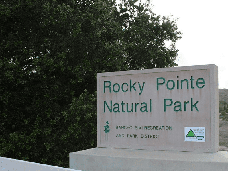 Rocky Pointe Natural Park sign with a tree in the background