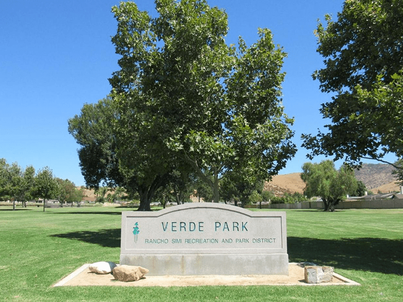 Verde Park sign with grass and trees surrounding