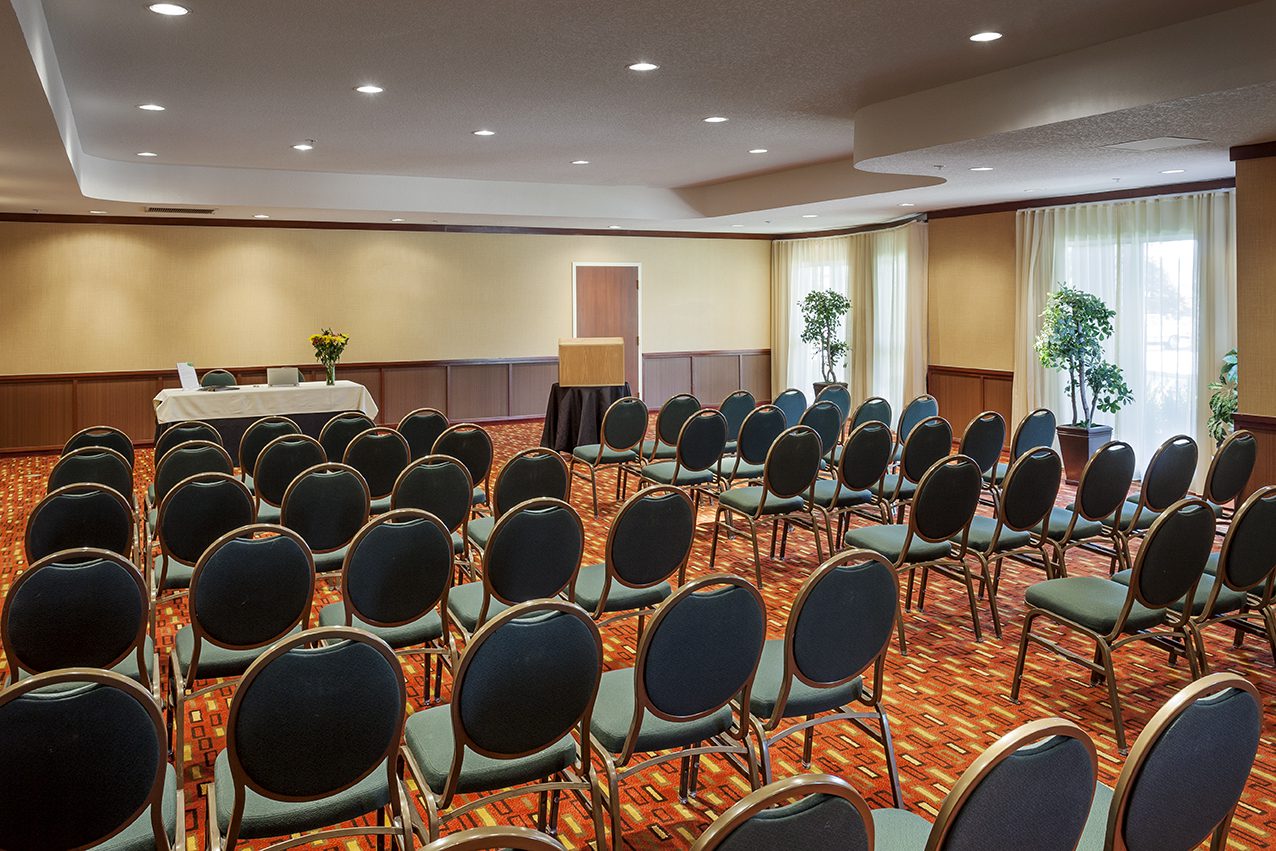 A conference room set up with chairs and a projector.