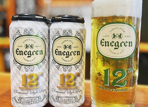 Two cans of Engren beer next to a stein