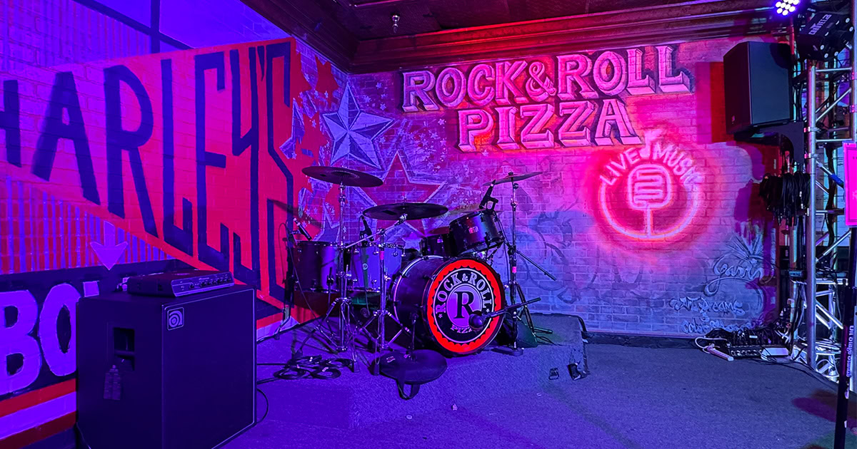 Enjoy live music at Simi Valley's Rock & Roll Pizza with a vibrant stage setup.