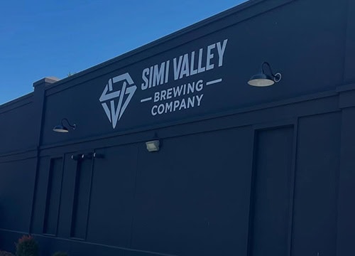 Exterior view of Simi Valley Brewing Company building with logo and signage.