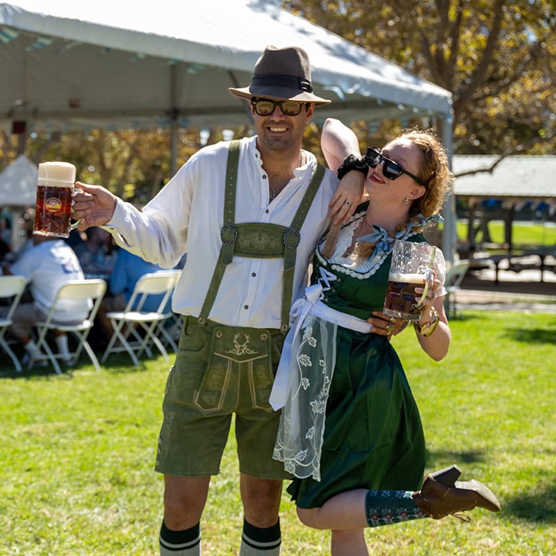 People enjoying beer and traditional attire at Oktoberfest in Simi Valley.