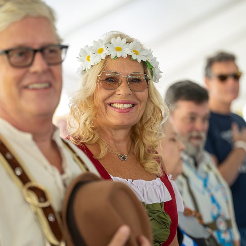 People enjoying Oktoberfest in Simi Valley with traditional attire and festive atmosphere.